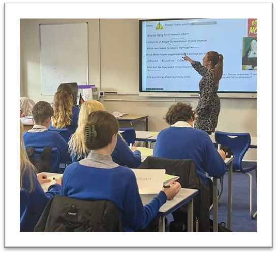 Teacher in classroom with pupils