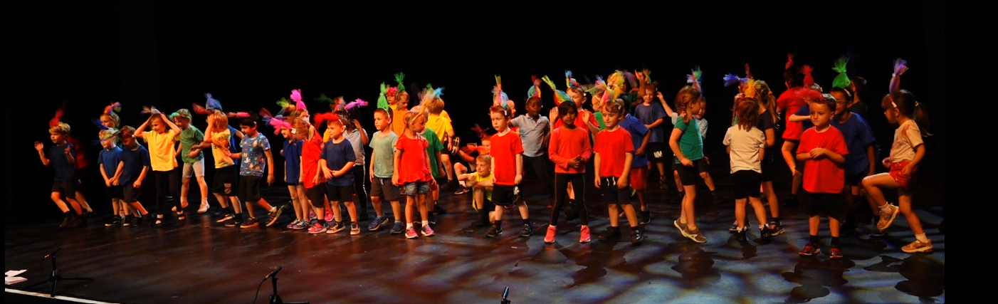 Greensand pupils performing on stage in a Trust-wide event