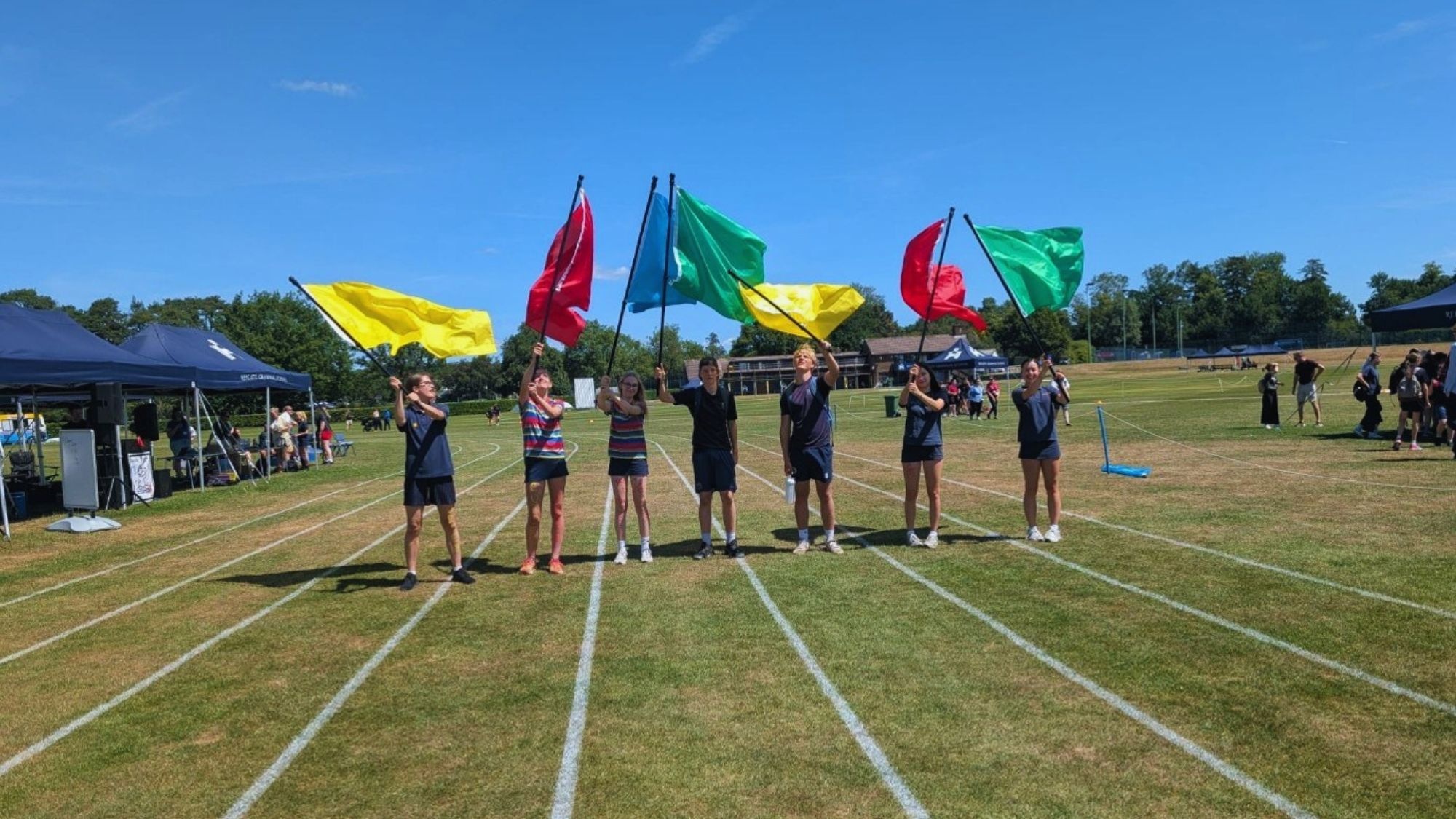 Reigate school children waving flags at sports day
